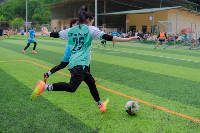 Female soccer player shooting the ball