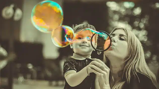 Boy with his mother blowing bubbles