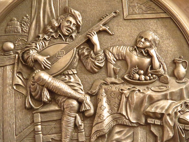 Metal relief of troubadour and woman