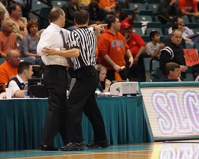 Referee and coach arguing