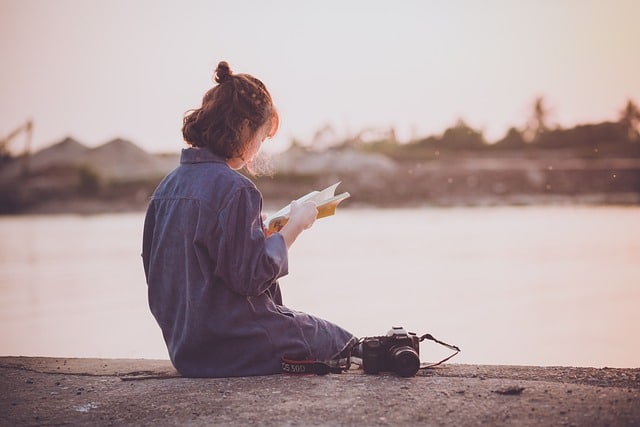 Girl reading by the river