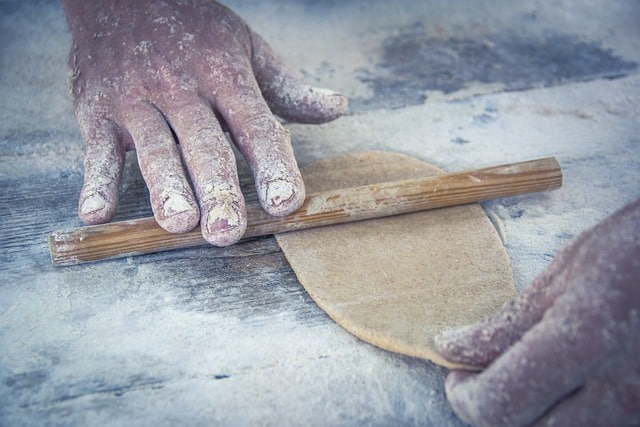 Man kneading with rolling pin