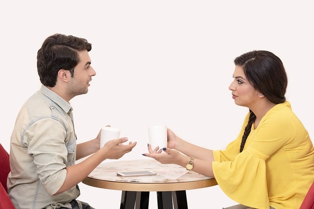 Man and woman talking and drinking coffee