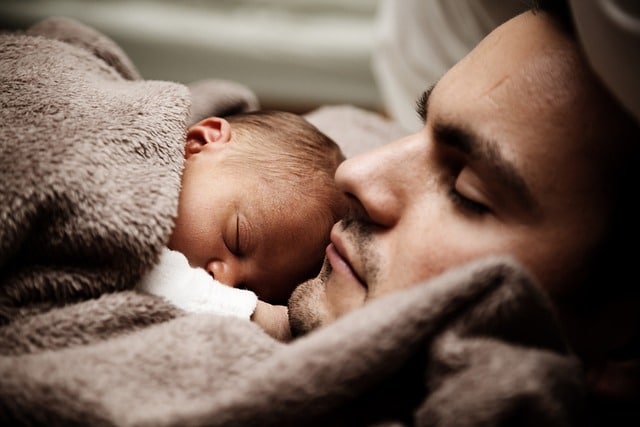 Man sleeping with his baby