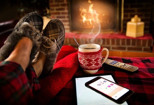 Person lounging in front of the fireplace