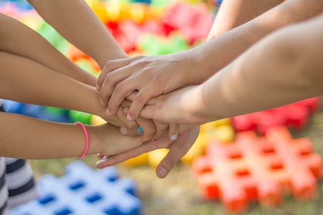 Several people joining hands