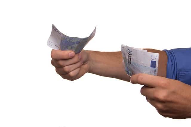 Man handing over euro bills