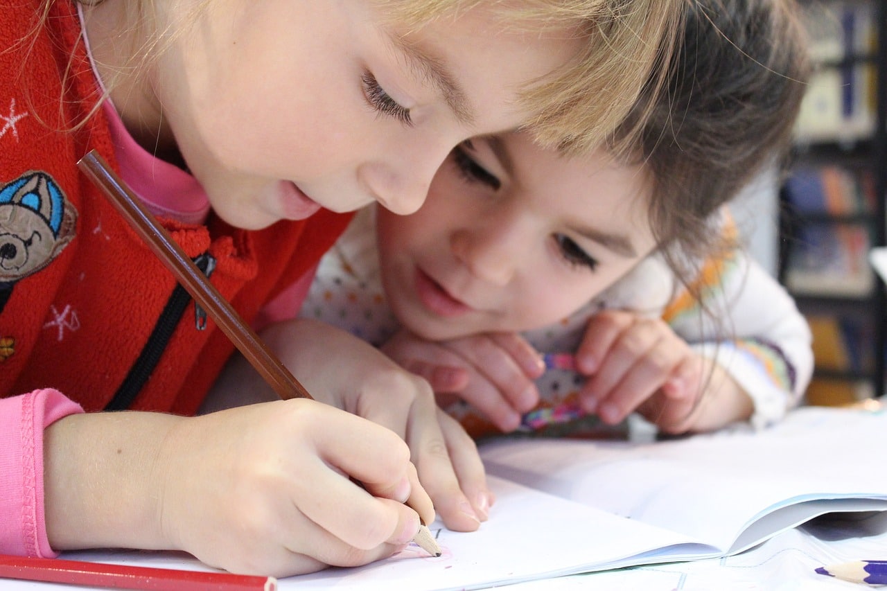 Girls writing in a notebook