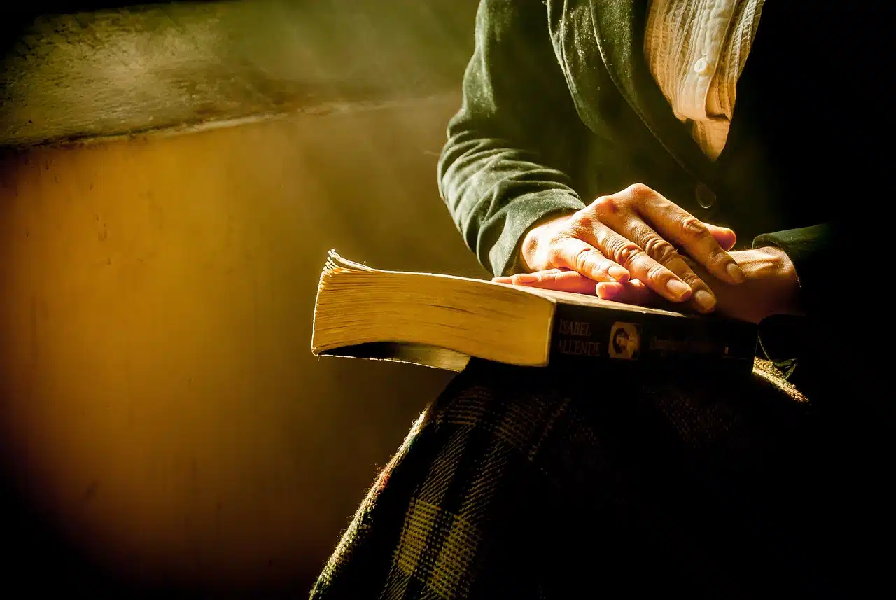 Woman posing her hands on the bible