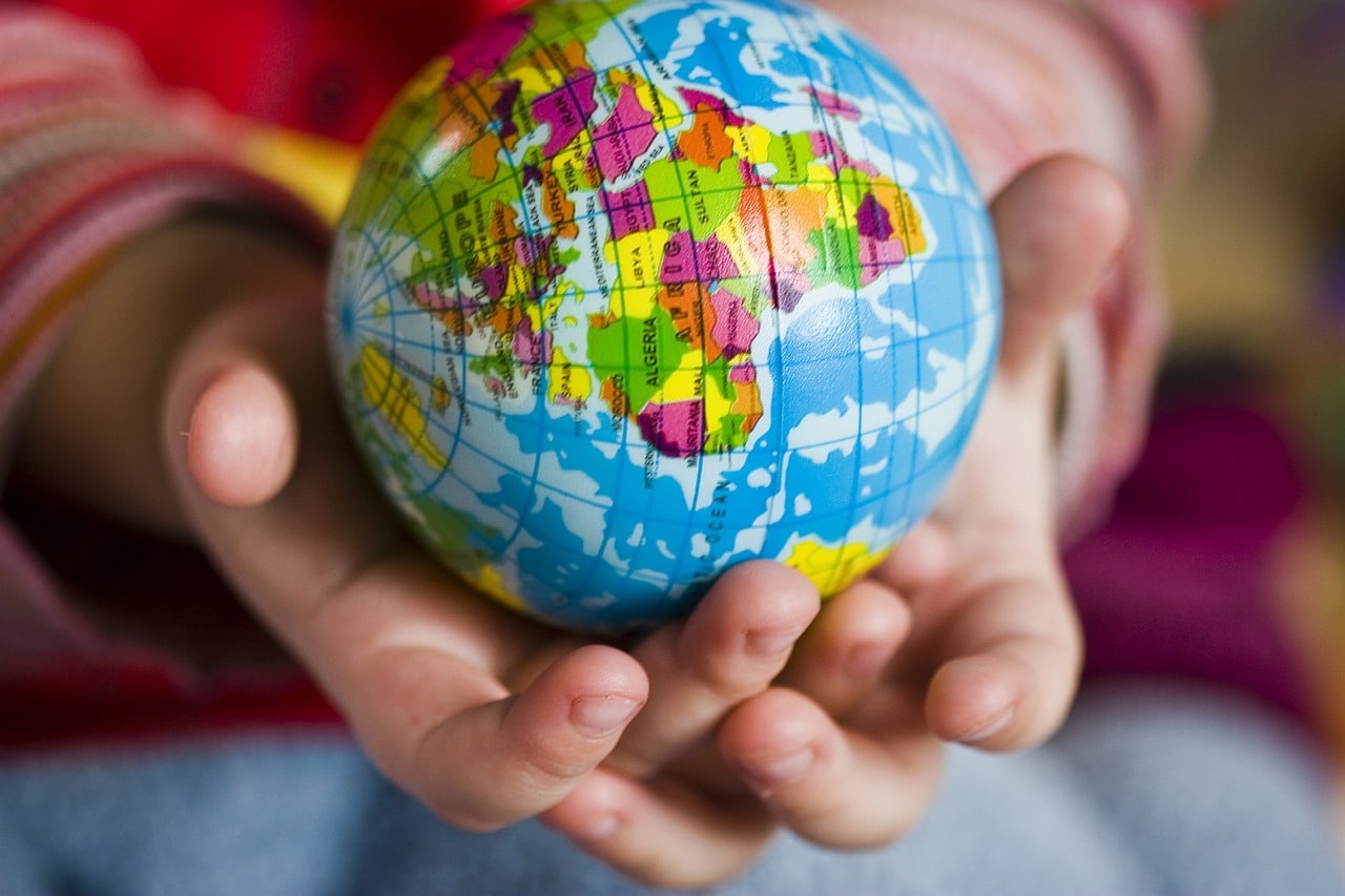 Boy holding world globe