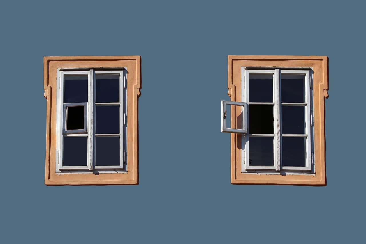 Two windows on blue wall