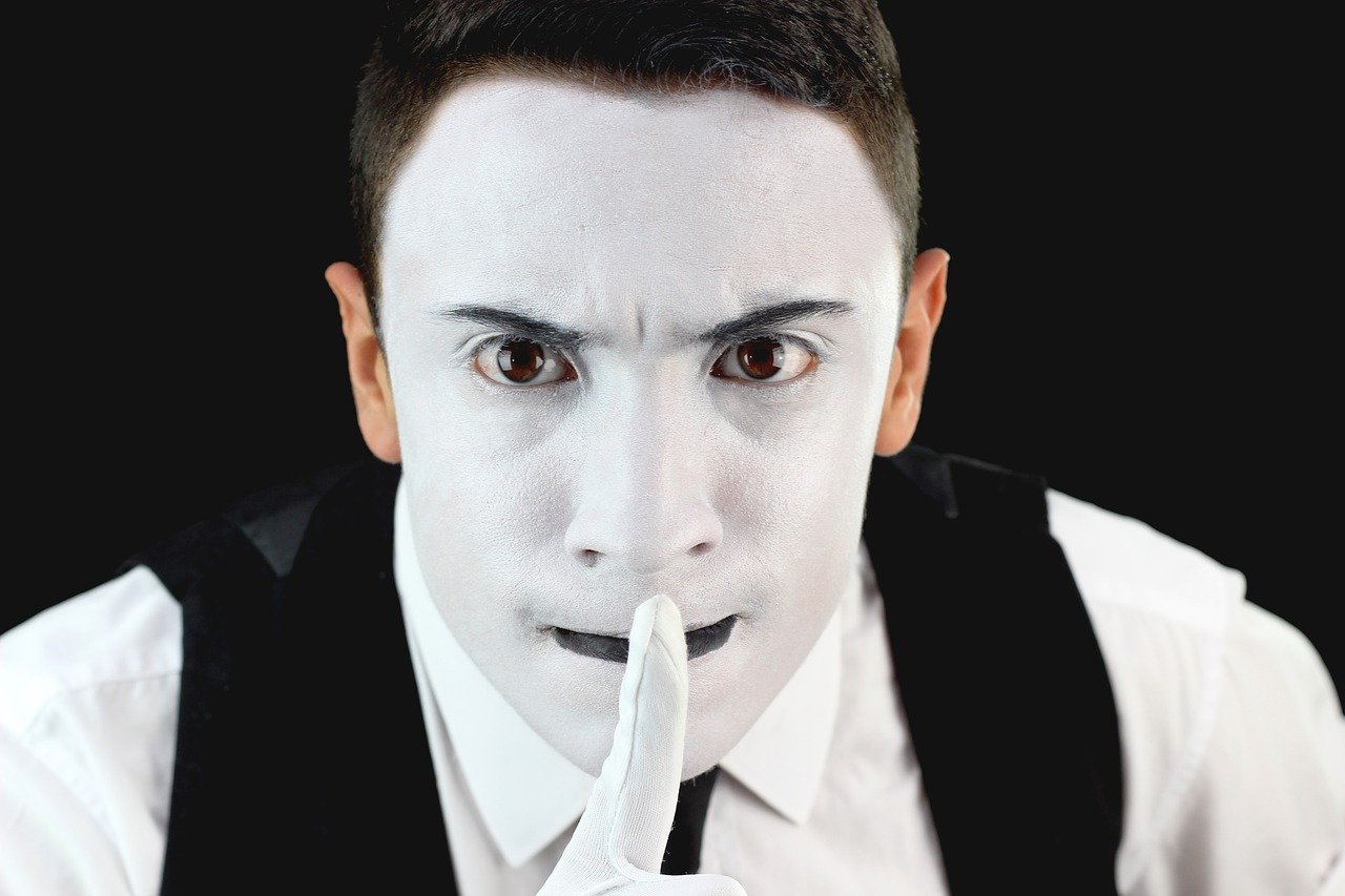 A mime making the silence gesture