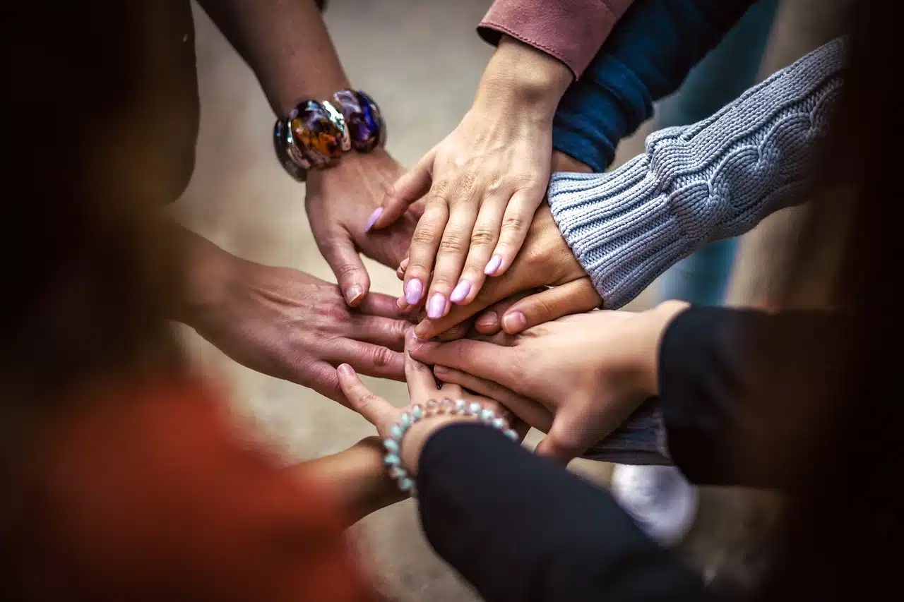 Group of people joining hands