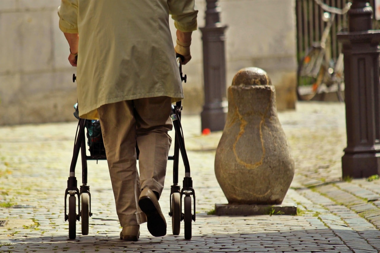 Elderly man using walker