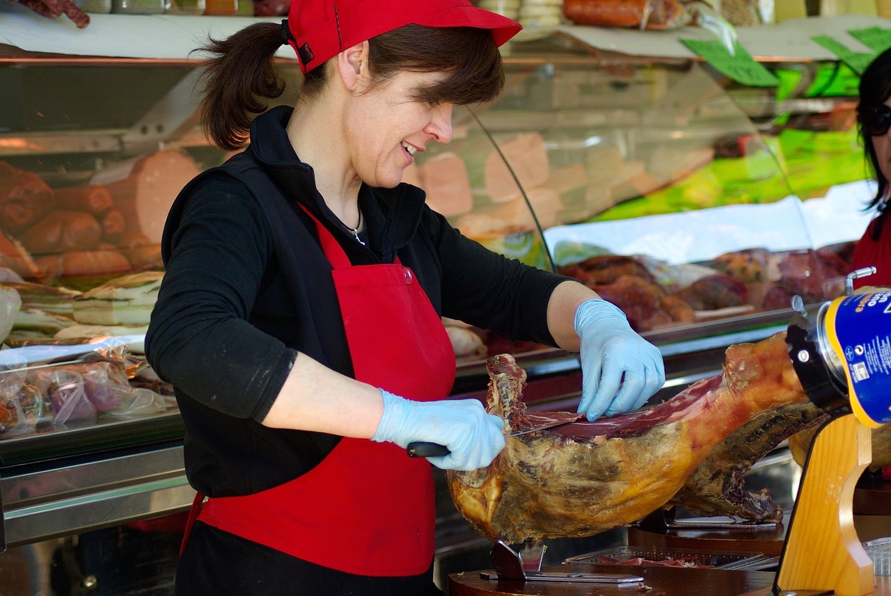 Butcher cutting a leg