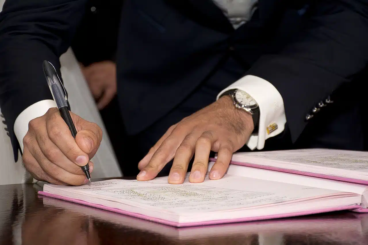 Man signing a document to certify its validity