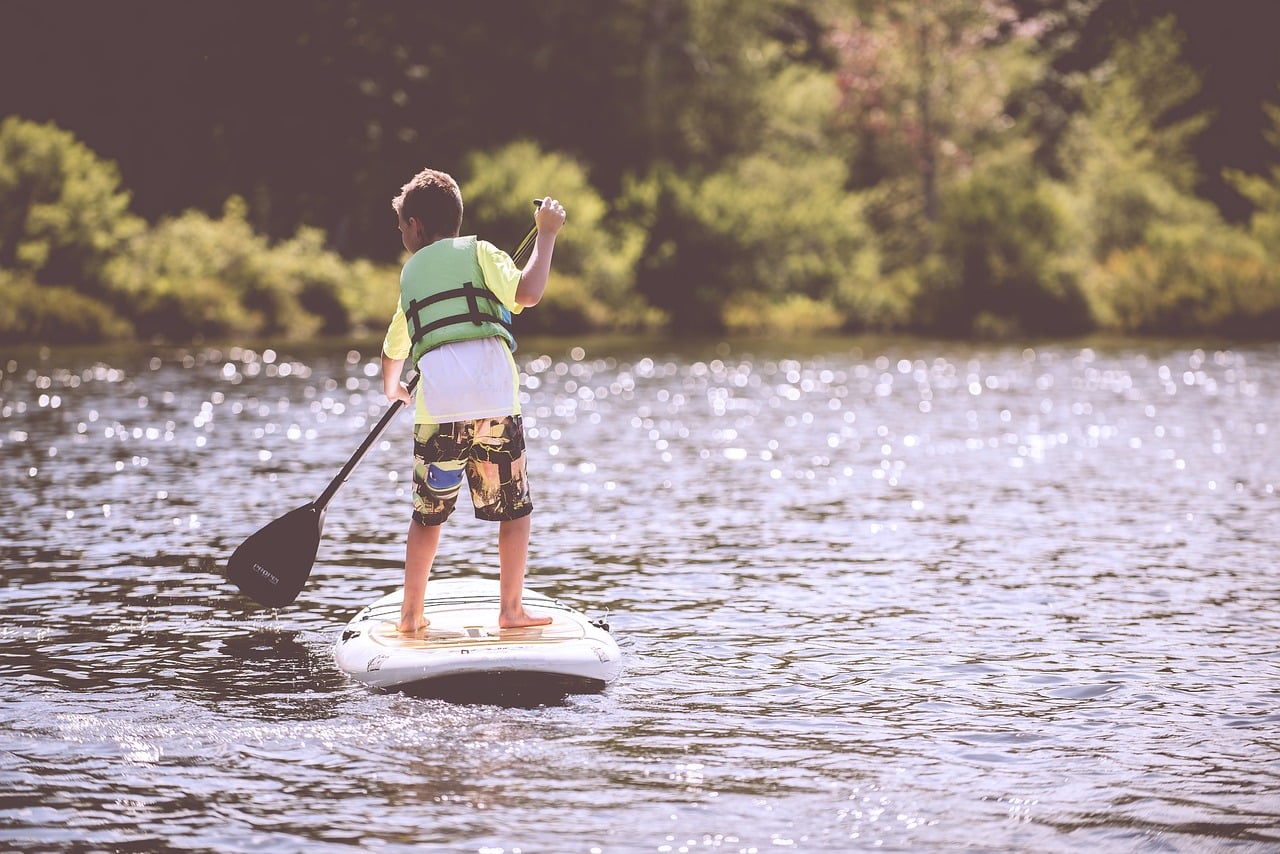 Boy sailing with life jacket