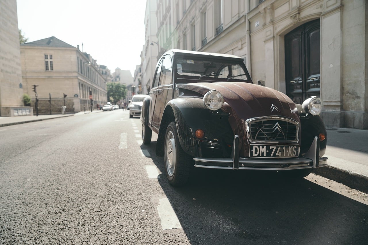 Old vehicle parked next to the sidewalk