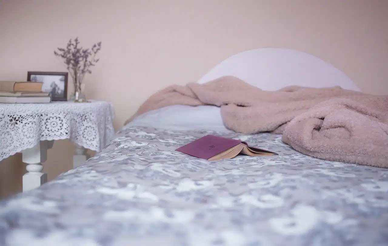 Book and blanket on bed