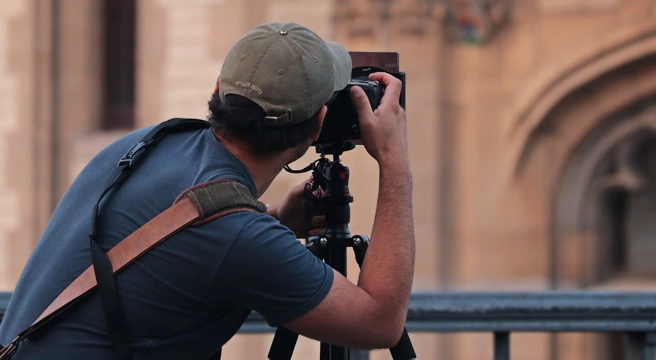 Photographer focusing on old building