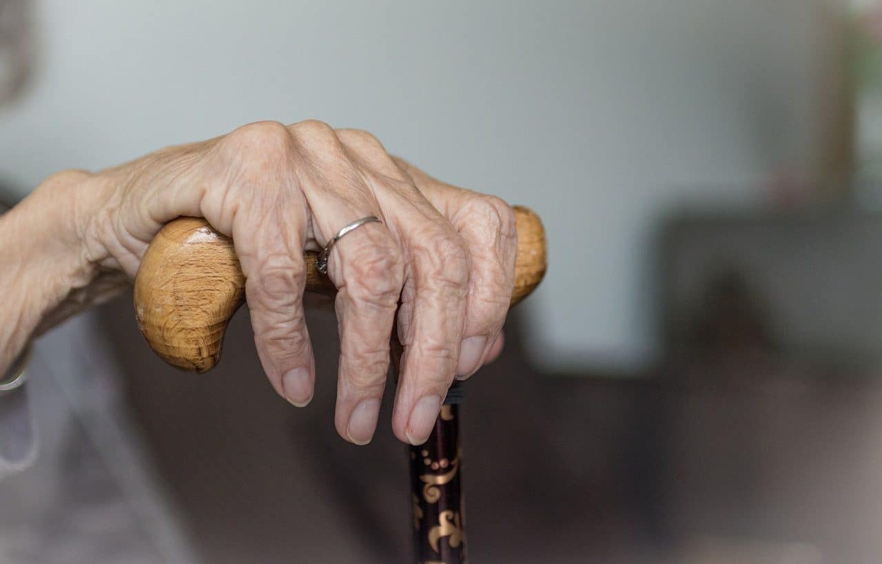 Elderly woman leaning on her cane