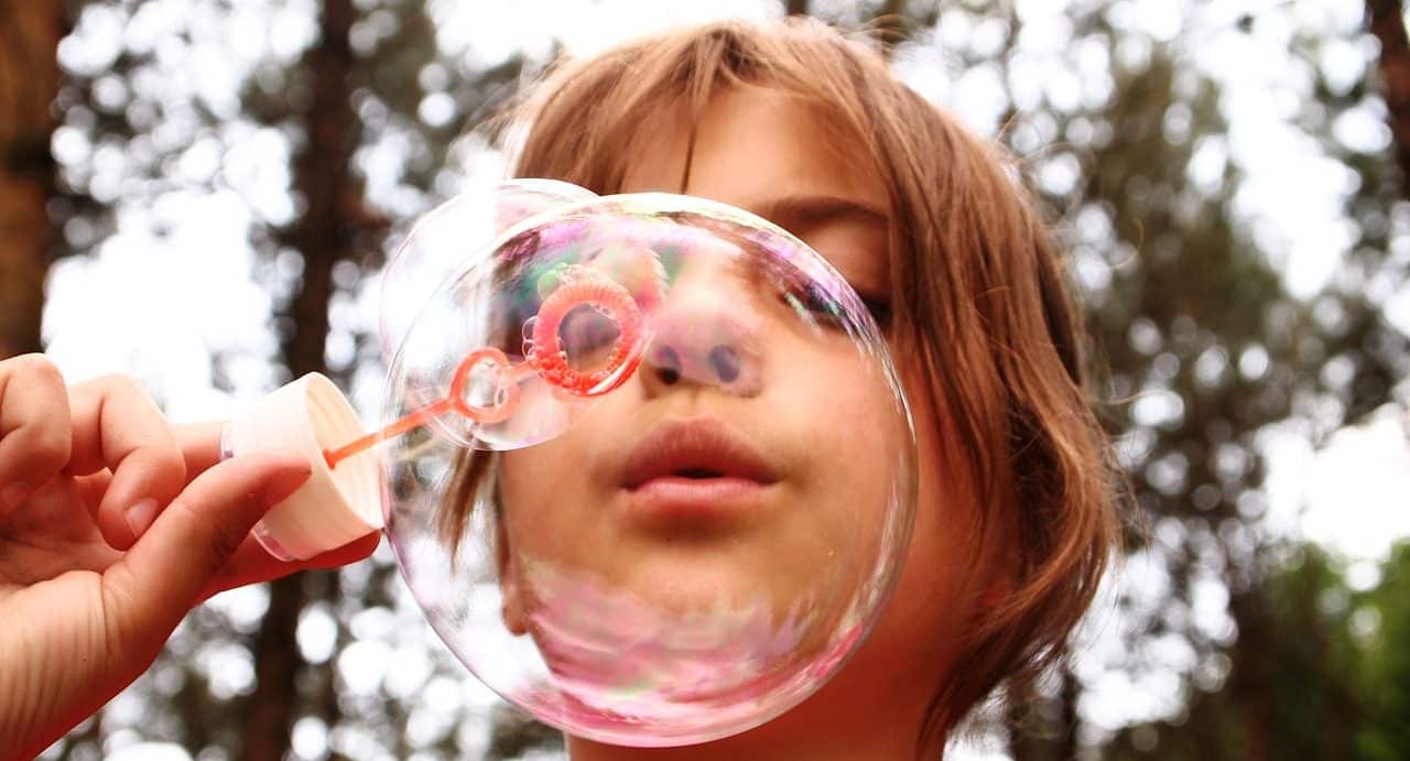 Girls playing blowing bubbles