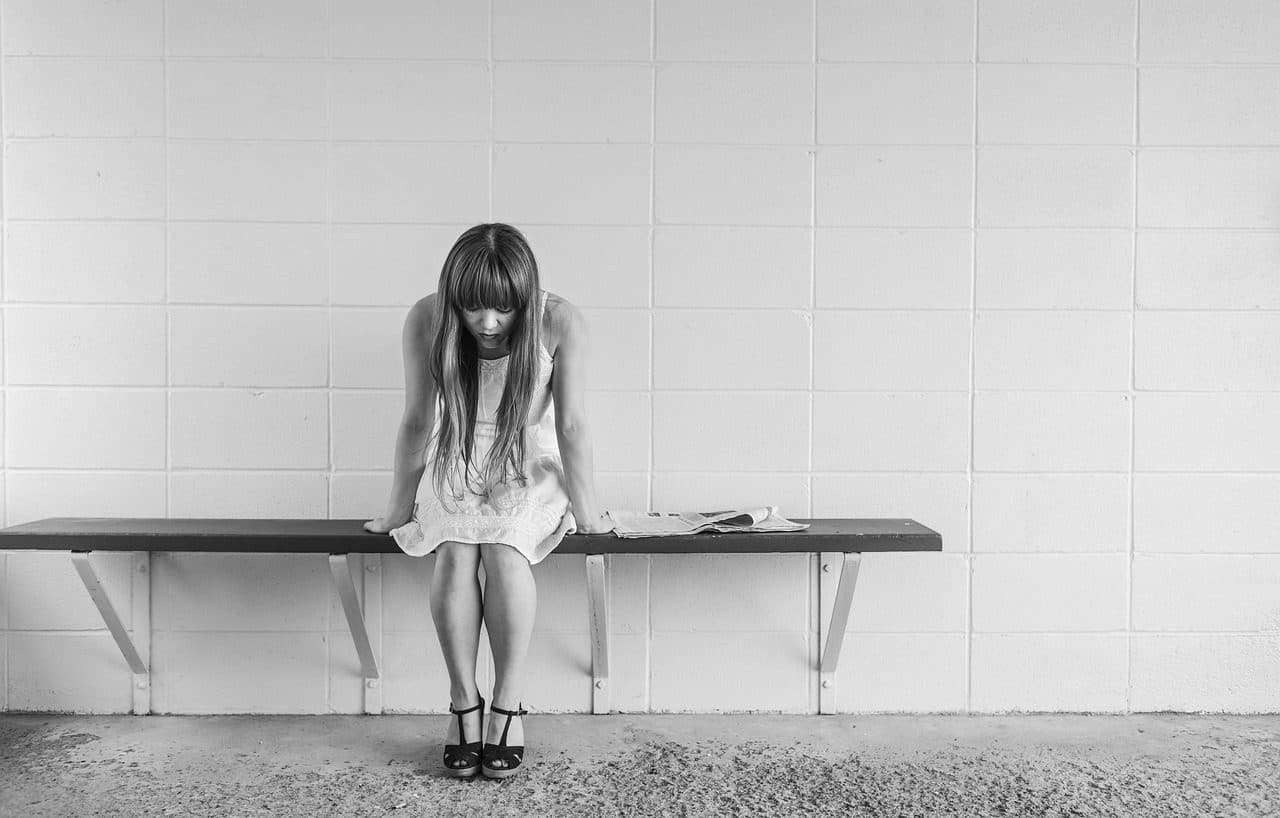 Girl sitting alone, listless