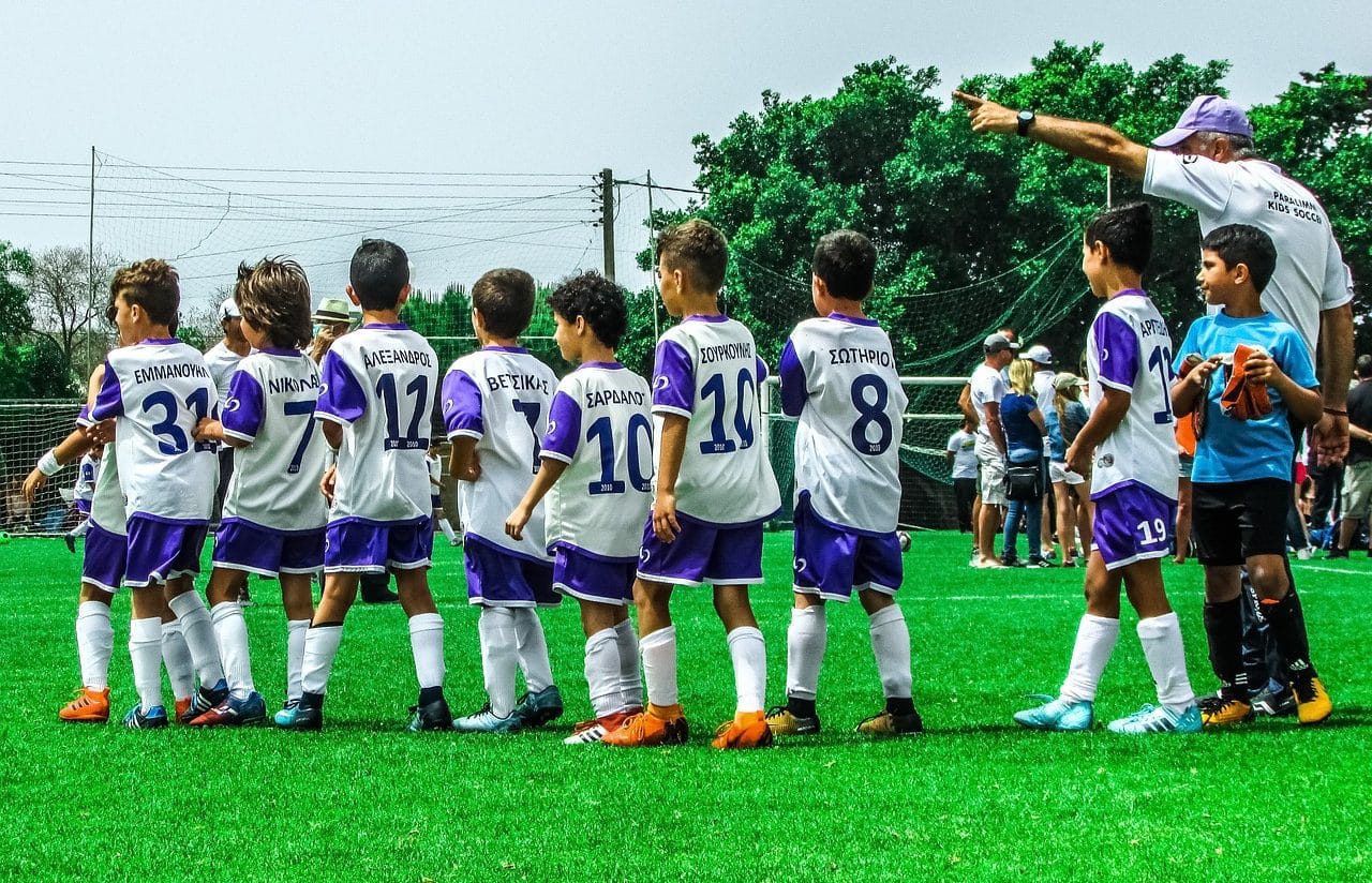 Soccer coach with children&#39;s team