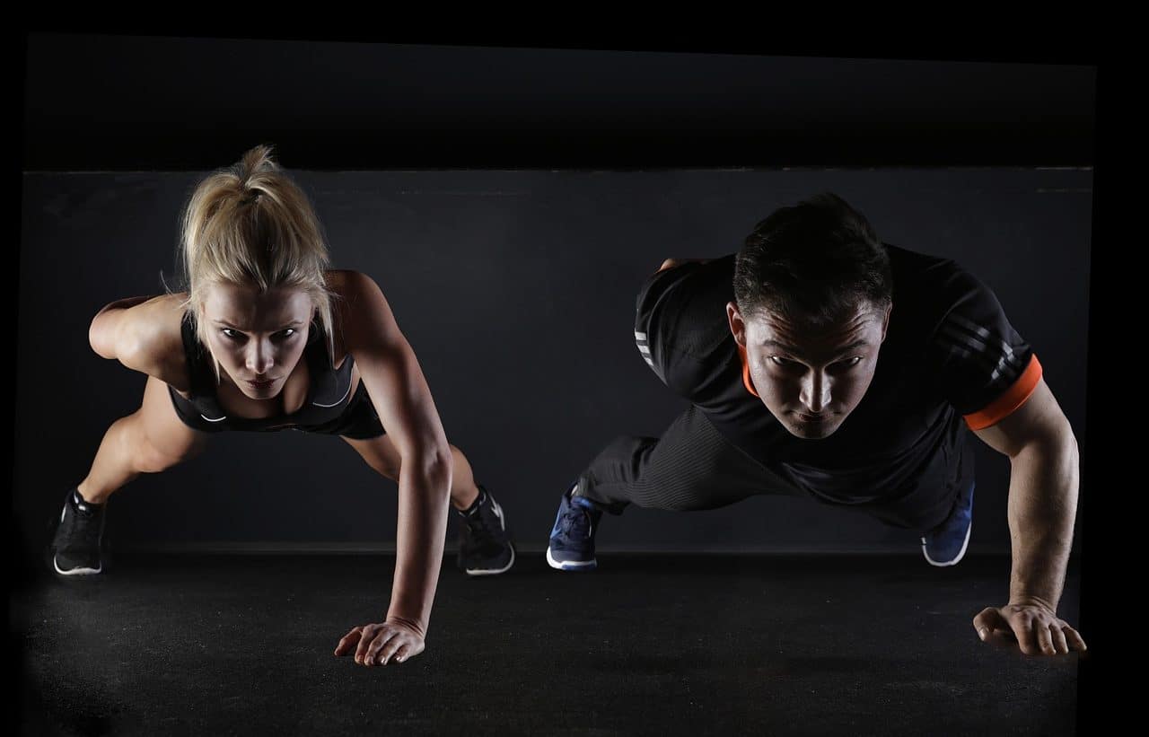 Woman and man doing push-ups