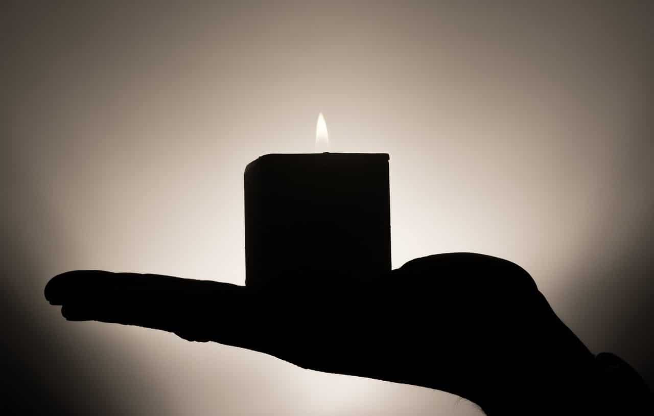 Person holding cubic candle