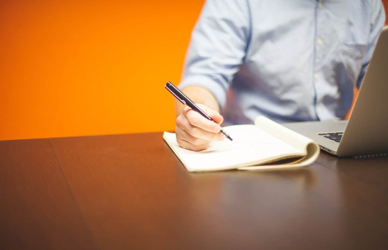 Man with a laptop and a notebook