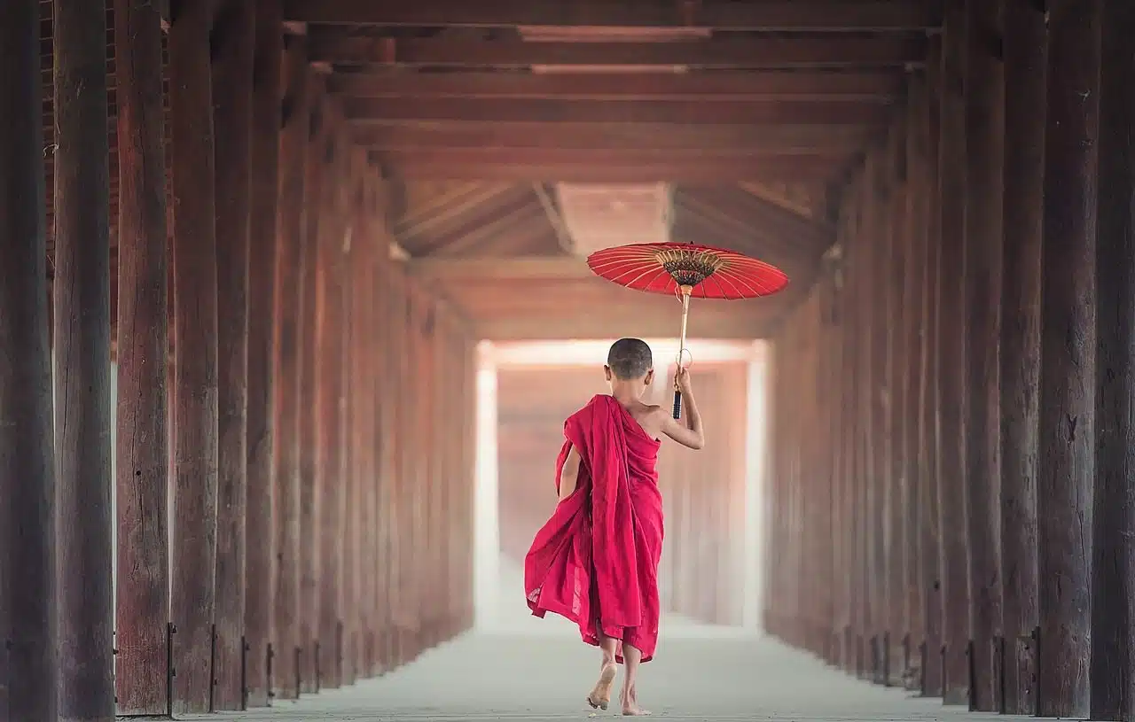 Japanese boy going through a temple tunnel