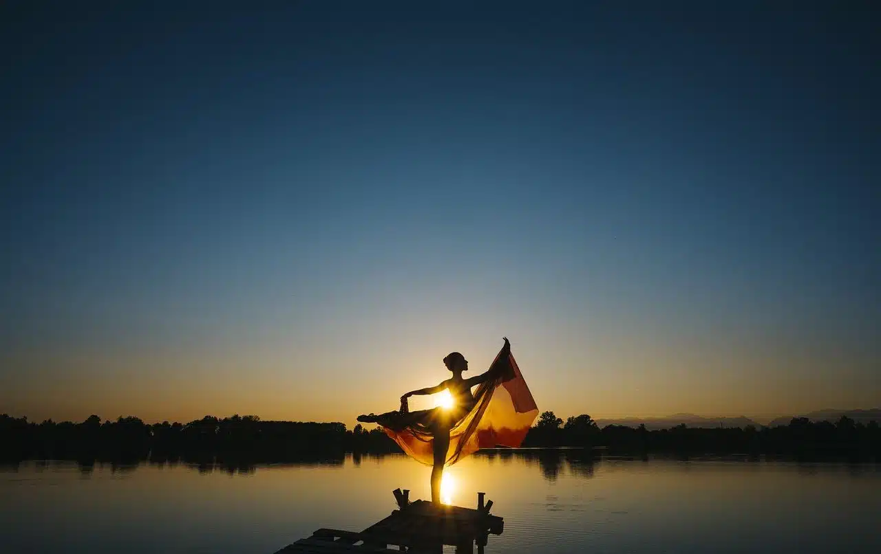 Woman dancing in front of a lake