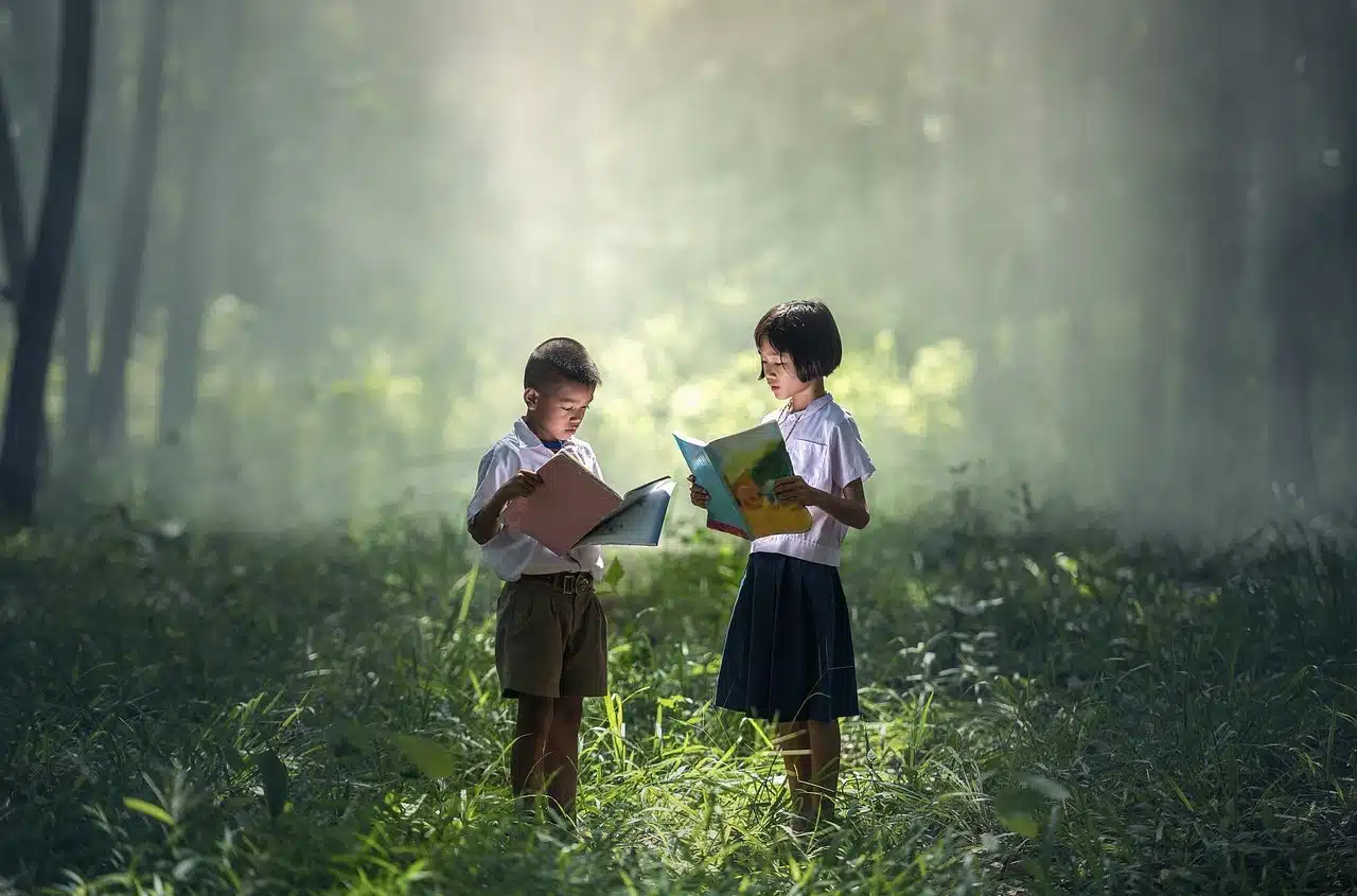 Two children reading in the forest