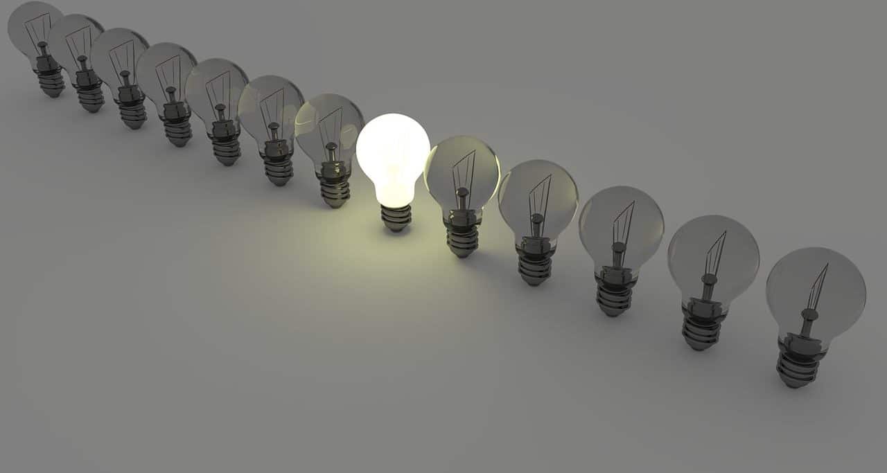 A light bulb on among many off ones