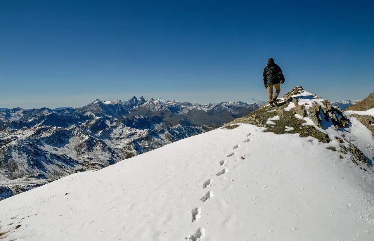 Man who has just reached a snowy peak