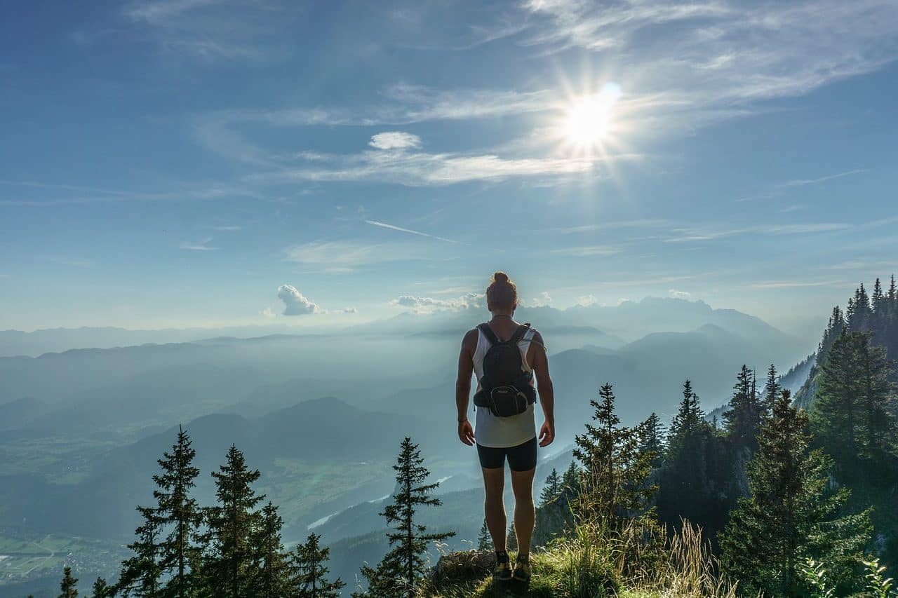 Boy admiring the landscape from a summit