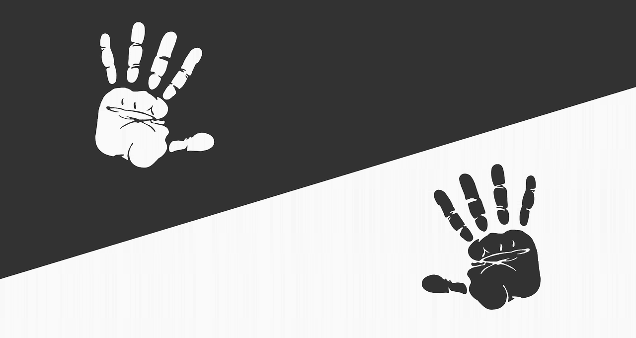 Black and white handprints on opposite colored backgrounds