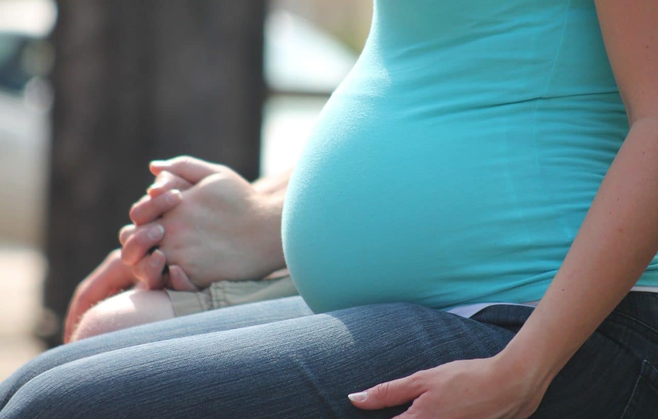 Pregnant woman sitting on a bench