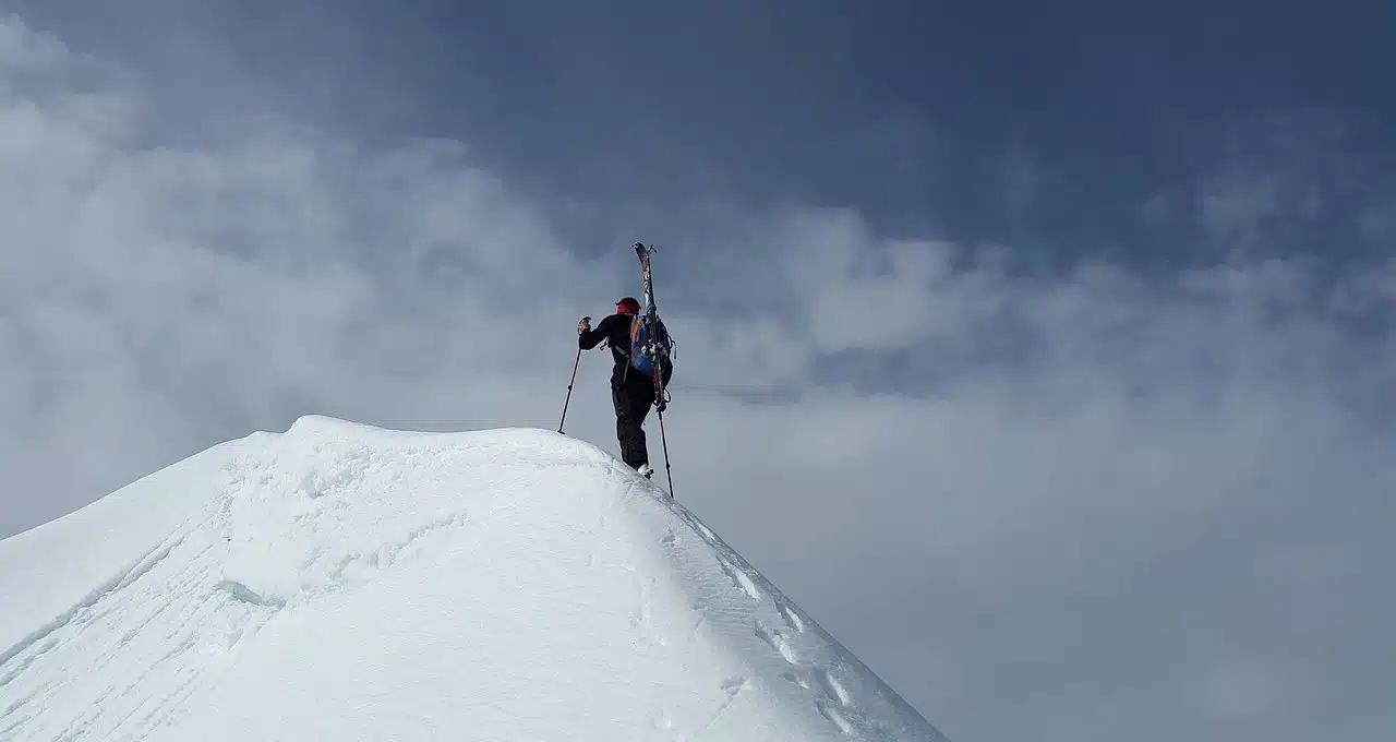 Mountaineer on top of a snowy mountain