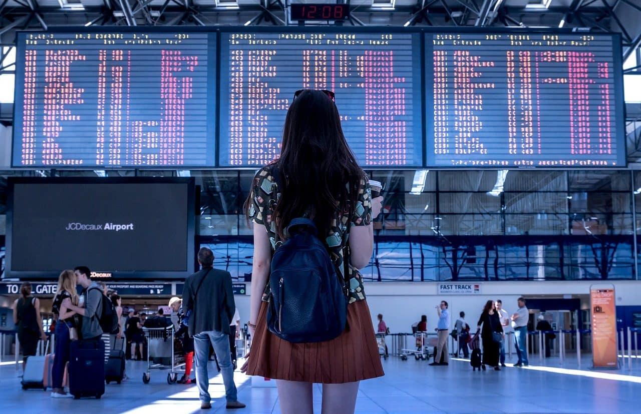 Woman looking at flight schedules at the airport