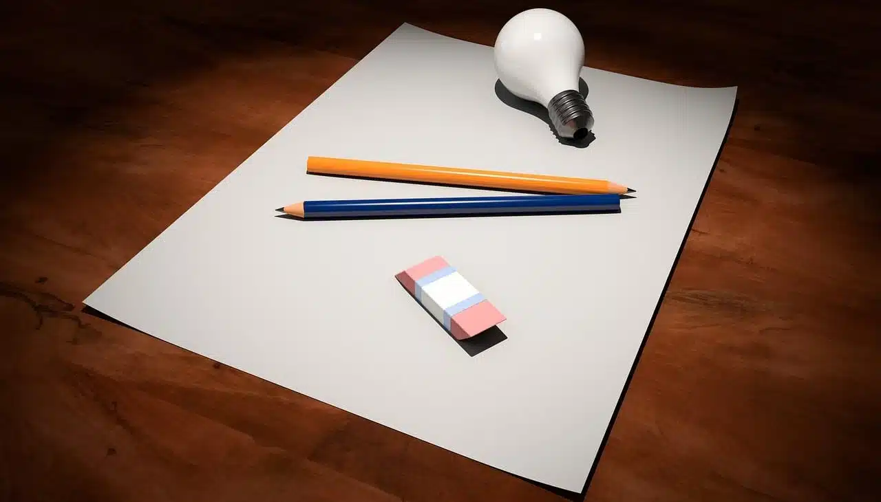 Blank sheet, pencils, eraser and electric light bulb