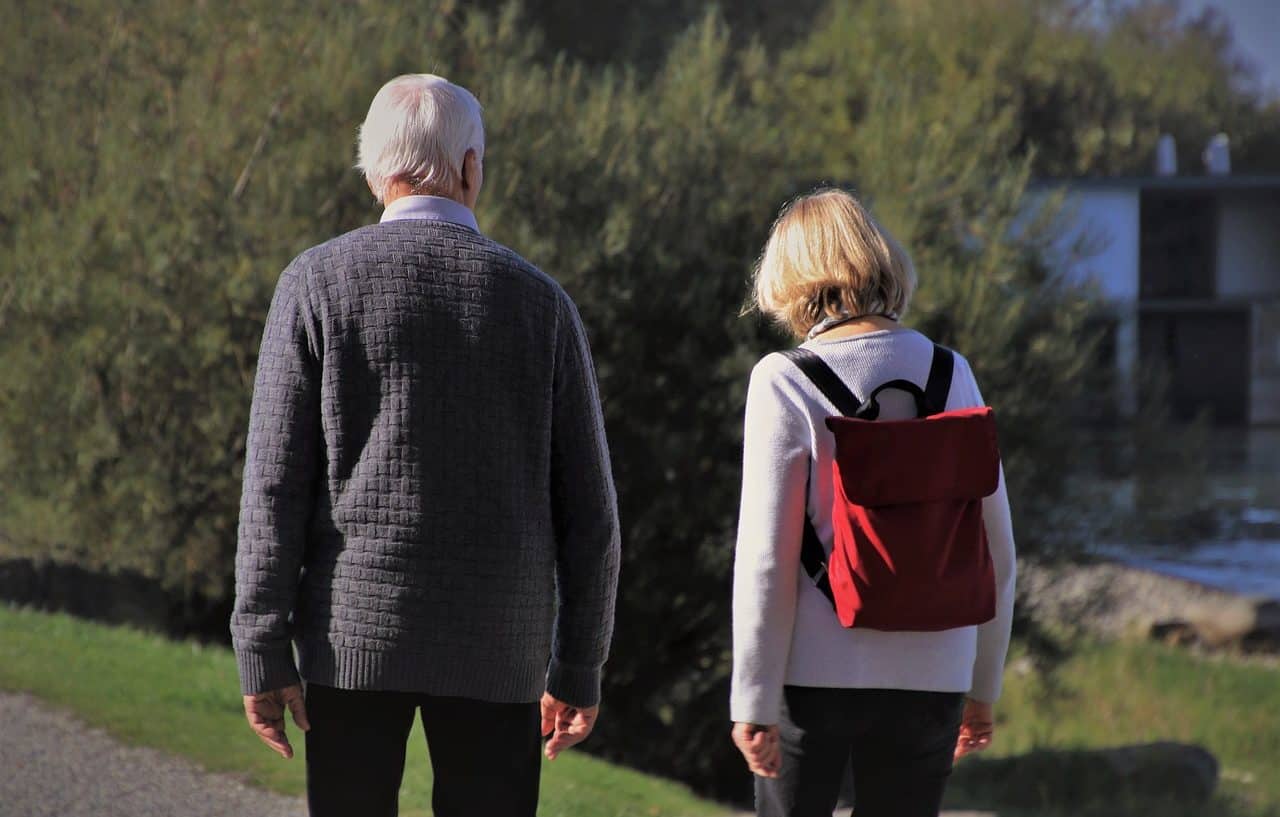 Senior man and woman walking in a park