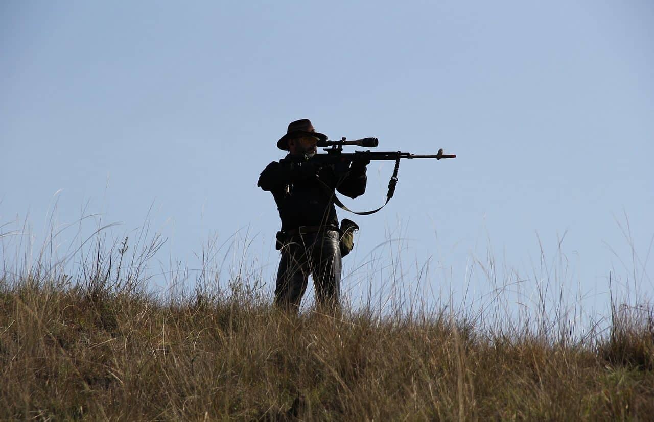 Hunter aiming his rifle