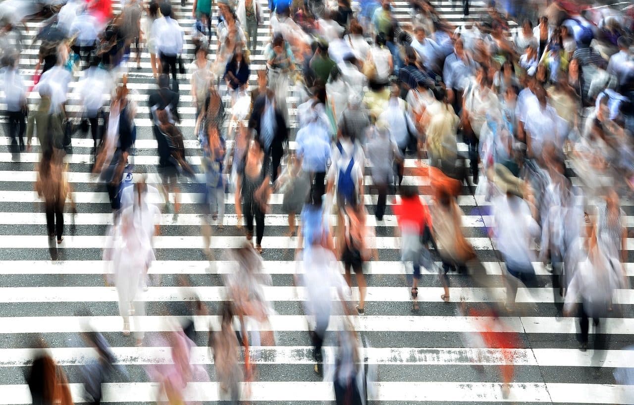 Defocused image of people crossing the street