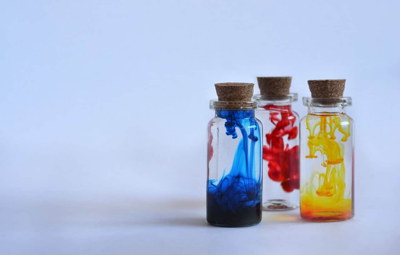 Three bottles with blue, red and yellow paint