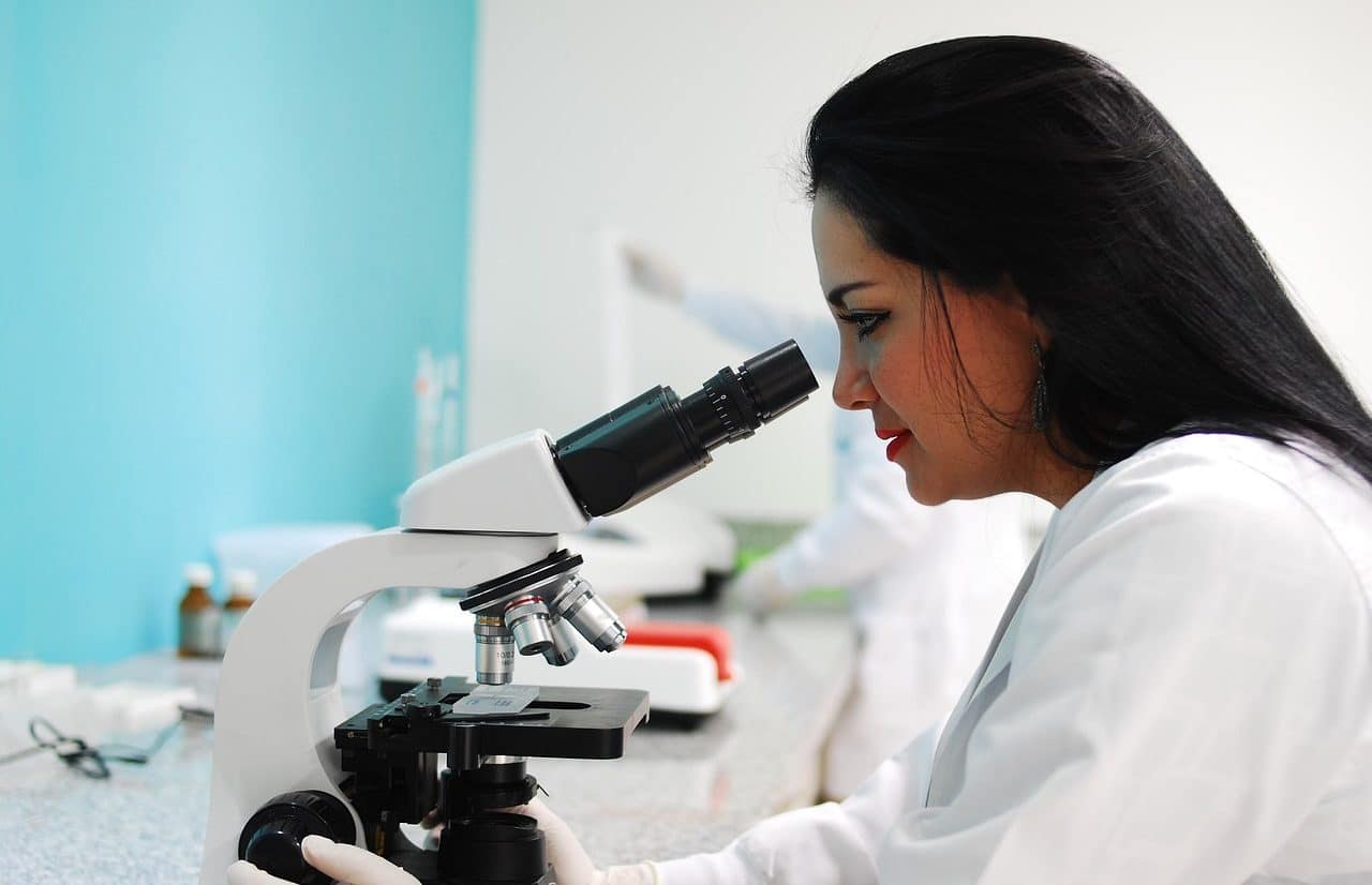 Scientist using a microscope