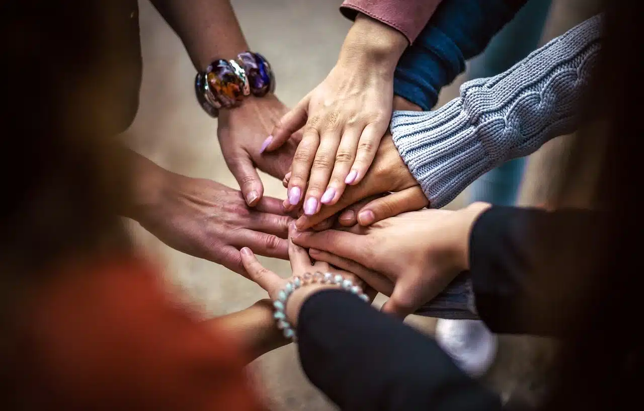 Several people joining hands