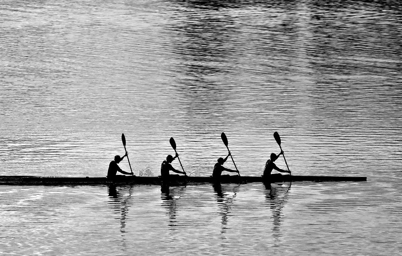 Four people in canoe, paddling