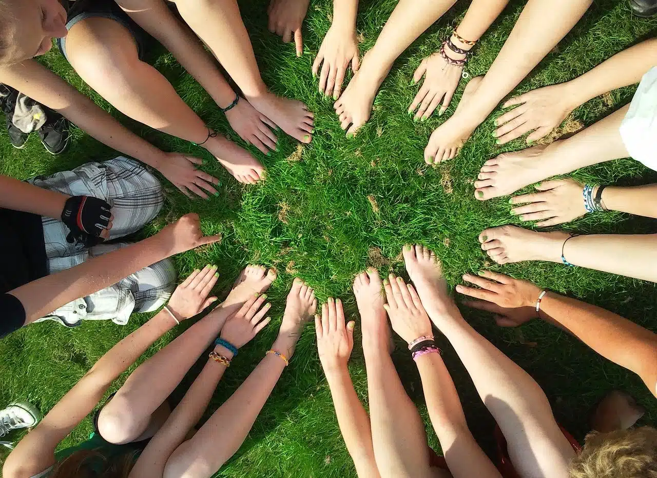 Many people joining hands in a circle